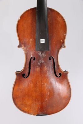 an old violin hanging from the back of a white wall
