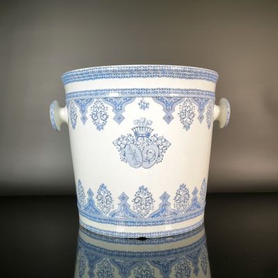 a large blue and white pot sitting on a table