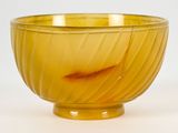 un bol en verre jaune contenant un petit poisson