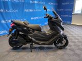 a picture of a motorcycle parked in front of a blue wall