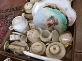 a box full of tea and coffee cups and saucers
