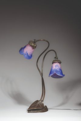 a lamp that is sitting on a table next to a wall