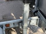 a trailer that has a metal pole attached to the side of it