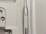 a white box with a silver toothbrush in it