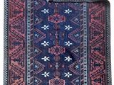 a close up of a blue and red rug on a white background