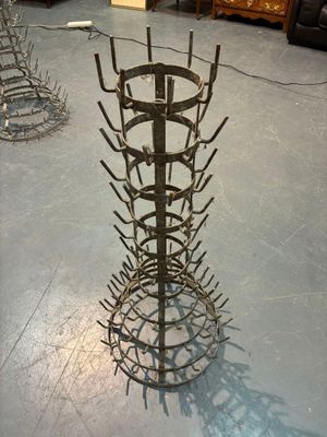 a metal rack with a bunch of nails on it