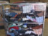 a large metal cart with a lot of clothes on it