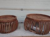 two wooden stools sitting on top of a table in front of a garage door