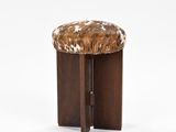 an image of a stool with a cow hide on it