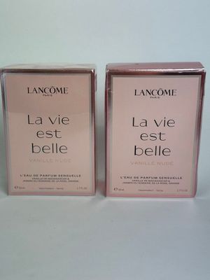two boxes of lancomie la vie belle perfume on a white surface