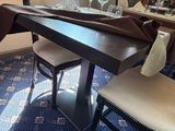 a dining room with a table, chairs, and a wine rack