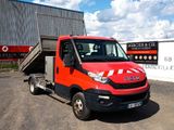 a red truck that is parked in front of a building