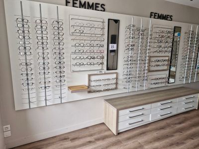 many rows of glasses on the wall in the store
