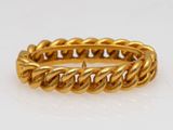 a gold ring with a twisted rope design