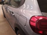 a car that is parked in a garage with the back lights on