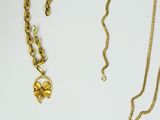 two gold necklaces with a four leaf clover pendant on a chain