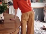 a woman that is standing in a kitchen with a table