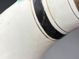 a close up of a white vase with a black stripe