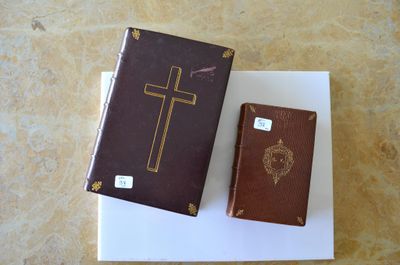 a brown book and a brown book with a cross on it