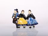two figurines of people sitting on a bench