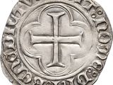 a silver coin with a cross on the front of it