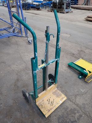 a hand truck that is sitting in the middle of a parking lot