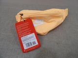 a yellow bag with a tag on it sitting on a bed