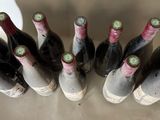 bottles of wine are lined up in a row on a table