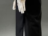 a mannequin wearing a white shirt and black skirt
