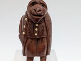 an image of a wooden sculpture of a bear wearing a coat
