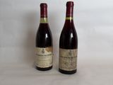 two bottles of wine sitting next to each other on a table