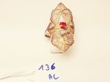an image of a gold ring with a red stone on it