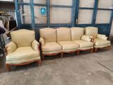 three couches and a chair in a room