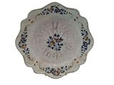 a white plate with blue and yellow flowers on it