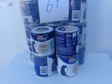 several cans of paint are stacked on top of each other on a table