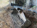 a bulldozer sitting in the middle of a pile of grass