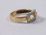 an image of a gold and diamond ring on a white surface