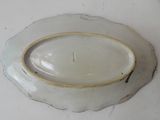 a white plate with a gold rim on a table