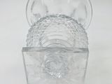 a clear glass container with a clear lid on a white surface