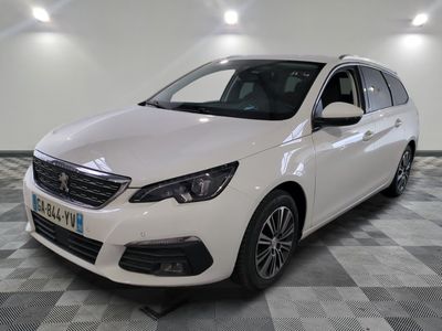 the white car is parked on a checkered floor in the garage