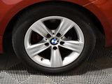 a close up of a bmw wheel on a red car