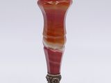 an image of a red and white vase sitting on top of a table