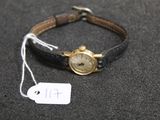 a small wrist watch with a tag attached to it