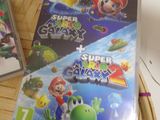 two nintendo wii games sitting on top of a table next to each other