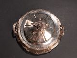 a silver plate with a clock on it on a table