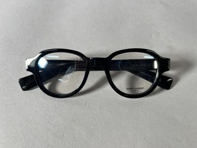black glasses with clear lenses on a white surface
