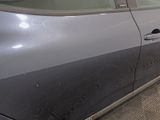 a car that has been painted gray and has a door handle