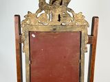 a wooden frame with a mirror on top of it