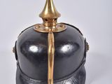 a black and gold helmet with a gold spiked top