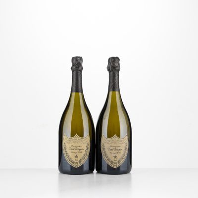 two bottles of champagne sitting on top of a table
